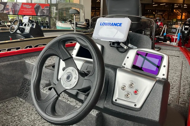 Slide: The Image of 2026 Tracker Pro Team 195 boat dashboard with steering wheel and Lowrance electronics. - 2