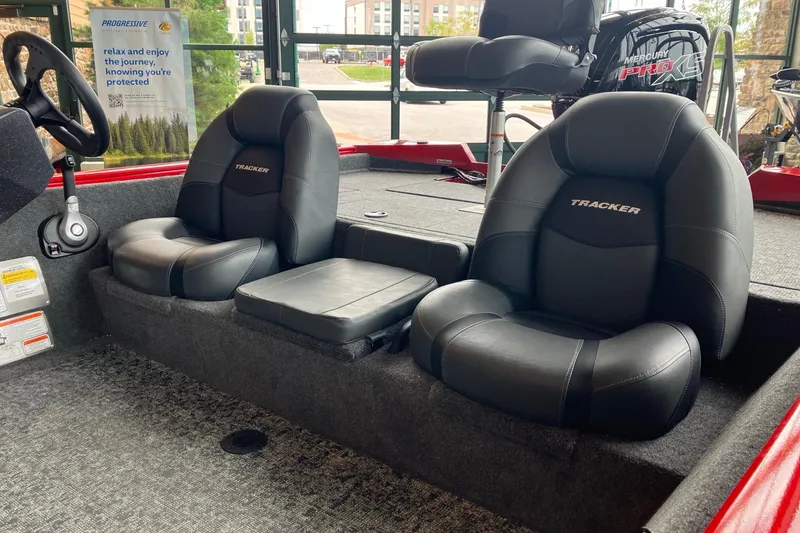 Slide: The Image of 2026 Tracker Pro Team 195 boat interior with black leather seats and Mercury Pro XS engine. - 3