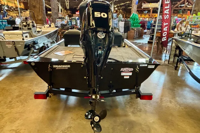 Slide: The Image of 2026 Tracker Bass Tracker Classic XL boat with Mercury 50 engine displayed indoors. - 2