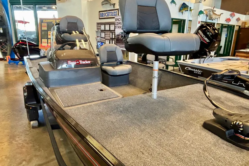 Slide: The Image of 2026 Tracker Bass Tracker Classic XL boat interior with seating and steering console. - 4