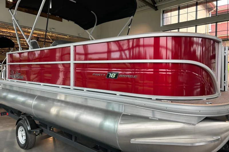 Slide: The Image of A red pontoon boat with silver details is indoors. - 4