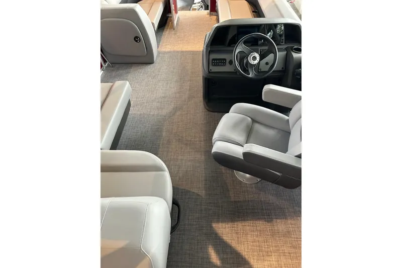 Slide: The Image of Interior of 2026 Sun Tracker Party Barge 18 DLX with seating and steering console. - 2
