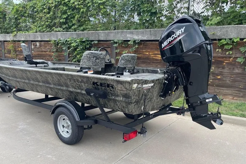 Slide: The Image of 2026 Tracker Grizzly 1754 SC boat with Mercury engine on trailer, parked outdoors. - 4