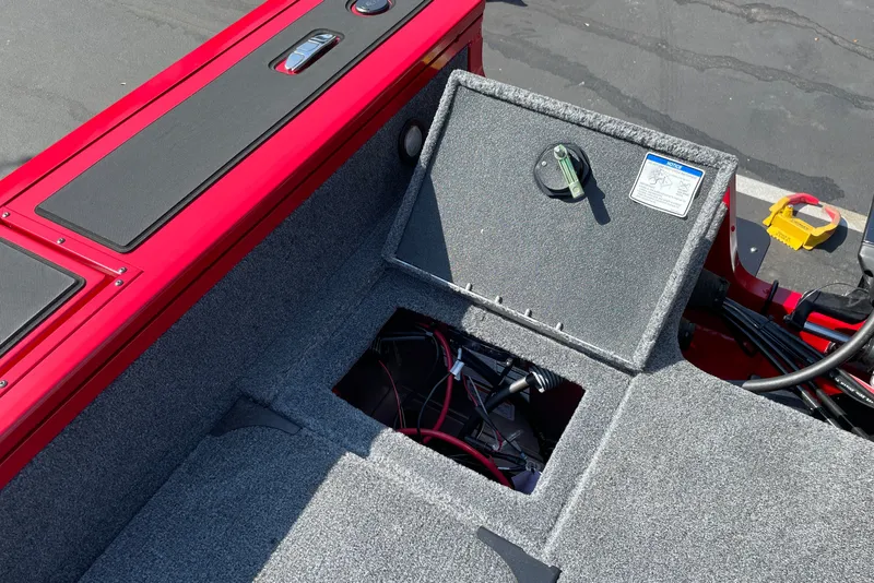 Slide: The Image of Open storage compartment on 2026 Tracker Targa V-18 Combo boat, showing wiring and interior details. - 20