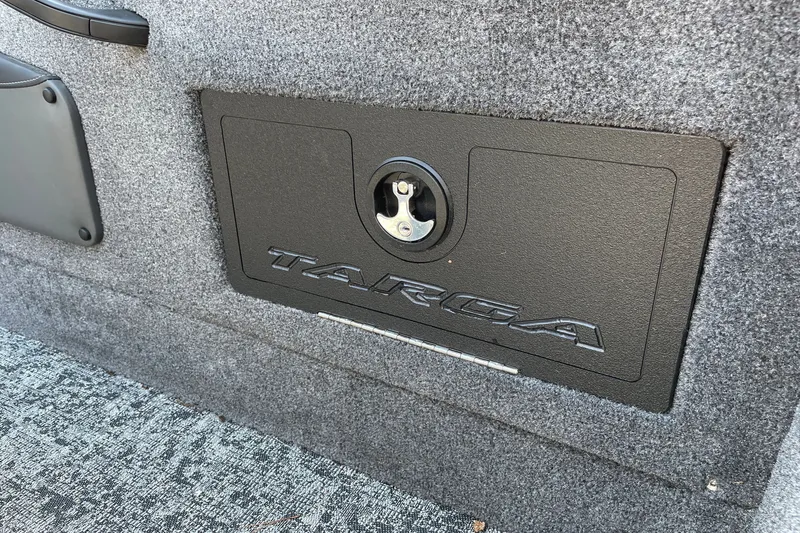 Slide: The Image of 2026 Tracker Targa V-18 Combo boat storage compartment with secure latch. - 29