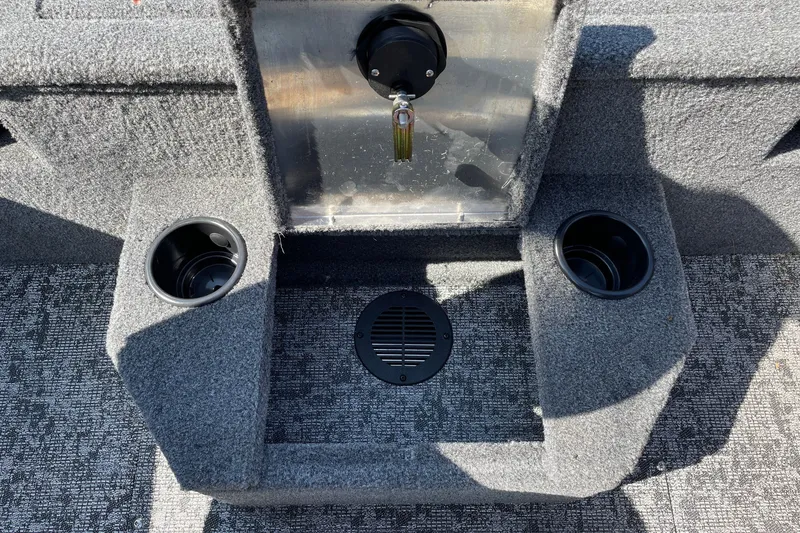 Slide: The Image of Interior of 2026 Tracker Targa V-18 Combo boat with cup holders and carpeted flooring. - 16