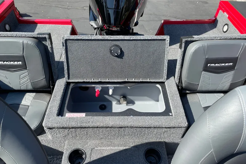 Slide: The Image of 2026 Tracker Targa V-18 Combo boat interior with storage compartment and seating. - 19
