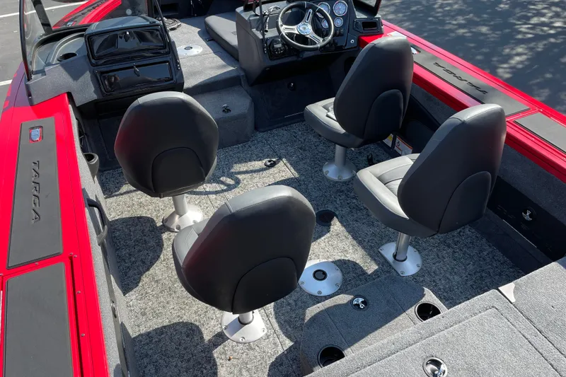 Slide: The Image of 2026 Tracker Targa V-18 Combo boat interior with four seats and steering console. - 24