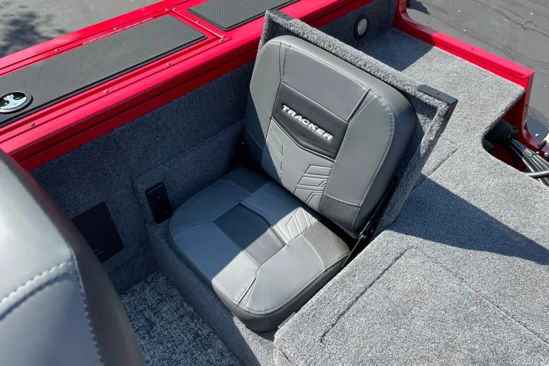 Slide: The Image of 2026 Tracker Targa V-18 Combo boat seat with gray upholstery and red accents. - 17
