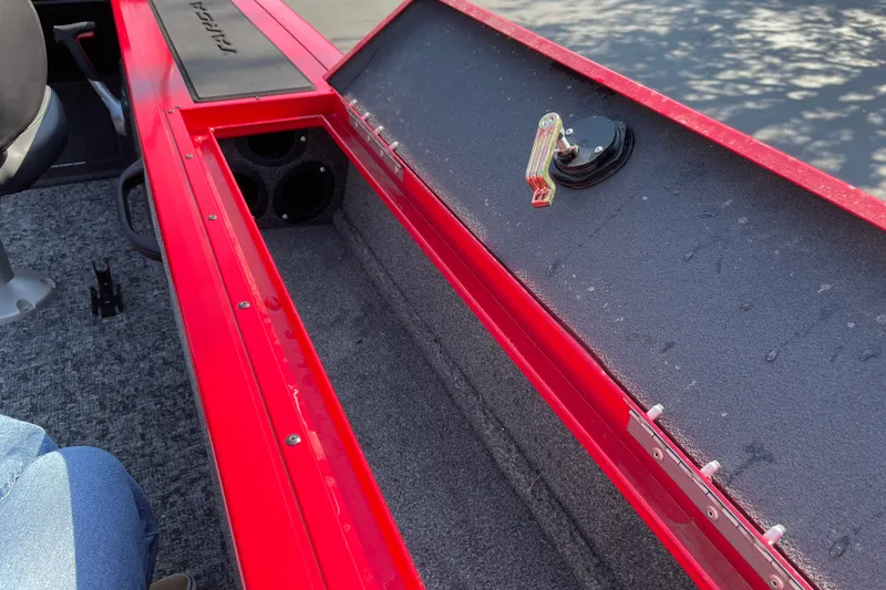 Slide: The Image of Interior of 2026 Tracker Targa V-18 Combo boat with red detailing and storage compartment. - 32