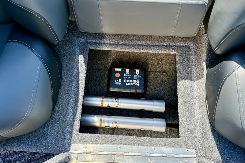 Slide: The Image of Interior storage compartment of 2026 Tracker Pro Team 175 boat with NOCO Genius charger. - 16