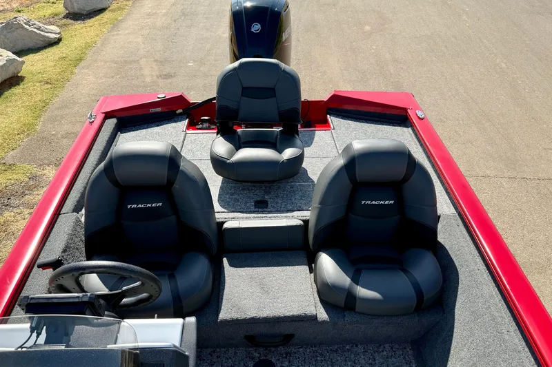 Slide: The Image of 2026 Tracker Pro Team 175 boat interior with three black seats and steering wheel. - 15