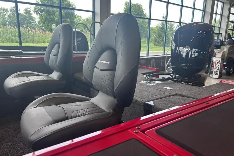 Slide: The Image of 2026 Tracker Targa V-18 Combo boat interior with plush seating and powerful engine. - 8