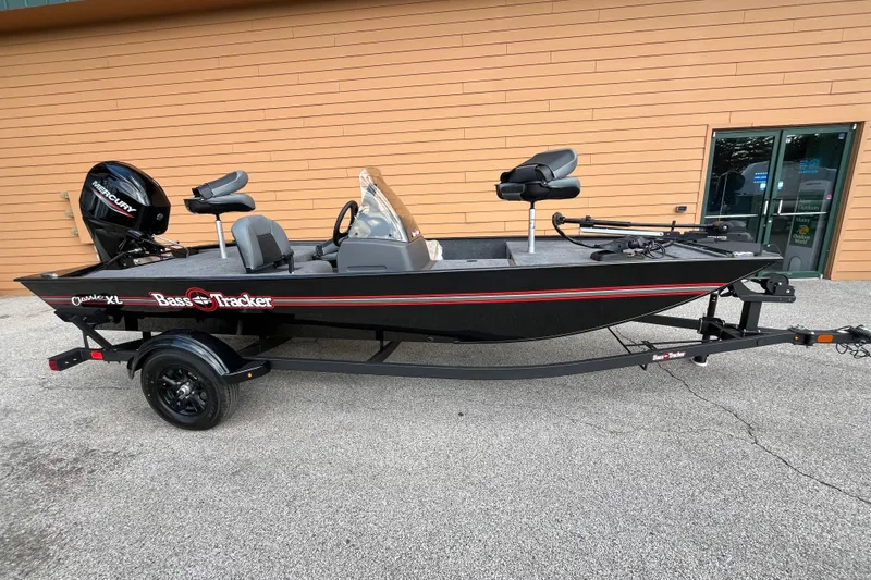 The Image of 2026 Tracker Bass Tracker Classic XL fishing boat with trailer, parked outdoors. - 0