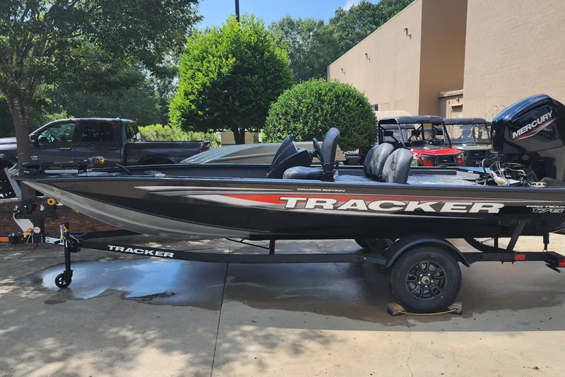 The Image of 2026 Tracker Pro Team 175 Crappie Edition boat on trailer, parked outdoors. - 0