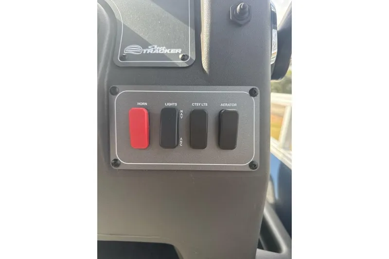 Slide: The Image of Control panel of 2026 Sun Tracker Bass Buggy 16 XL Select with switches for horn, lights, and aerator. - 14