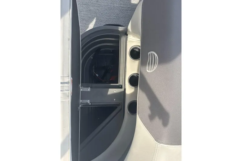 Slide: The Image of 2026 Sun Tracker Bass Buggy 16 XL Select interior storage compartment with cup holders. - 13