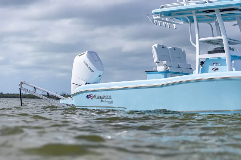 Slide: The Image of 2026 Crevalle 26 HCO boat on water, featuring Mercury engine, under cloudy sky. - 15