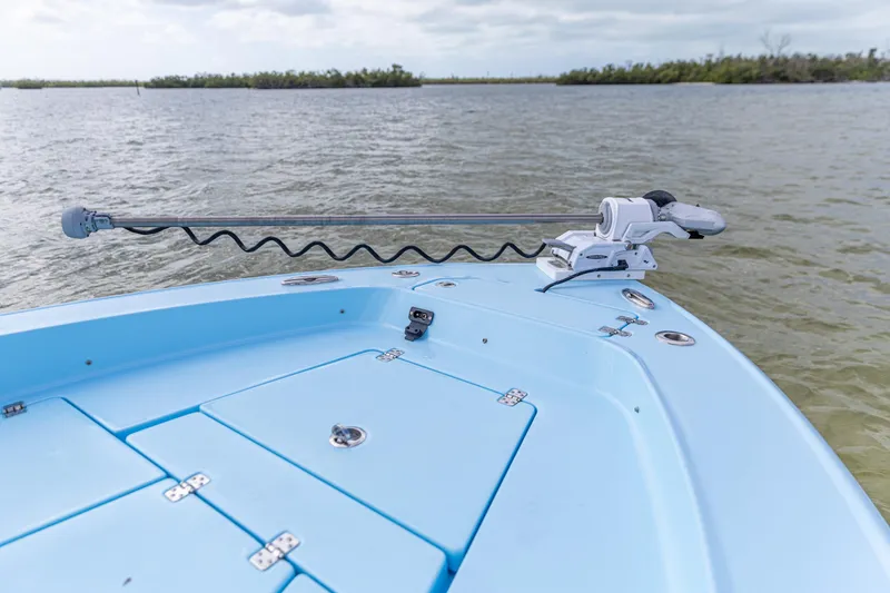 Slide: The Image of 2026 Crevalle 26 HCO boat bow with trolling motor on calm water. - 3