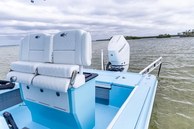 Slide: The Image of 2026 Crevalle 26 HCO boat with white seating and Mercury outboard motor on water. - 9