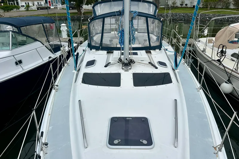 Slide: The Image of 2002 Hunter Passage 420 sailboat docked, showcasing deck and cockpit area. - 14