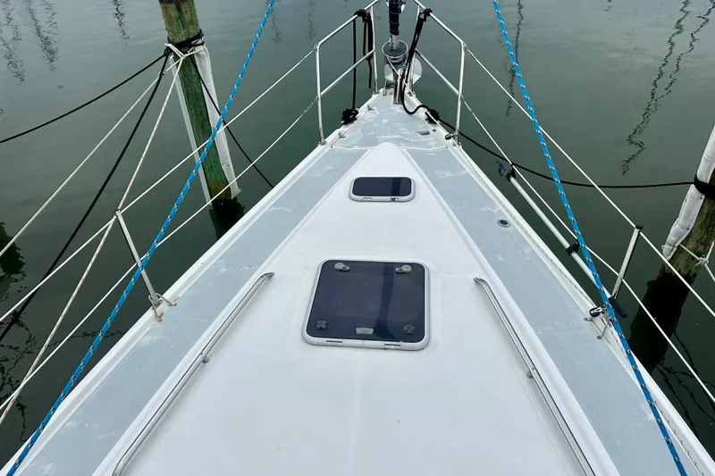 Slide: The Image of Deck view of 2002 Hunter Passage 420 sailboat, featuring hatches and railing. - 15