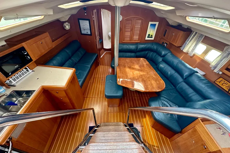 Slide: The Image of Interior of 2002 Hunter Passage 420 yacht with wood finish and blue seating. - 21