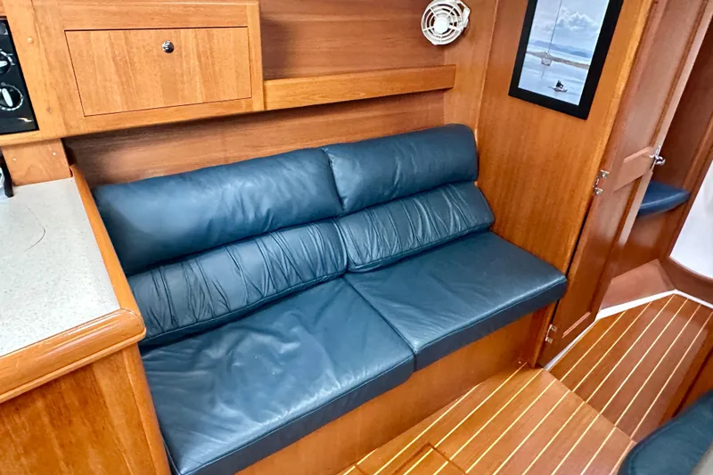 Slide: The Image of Luxurious interior of 2002 Hunter Passage 420 yacht with blue leather seating. - 23