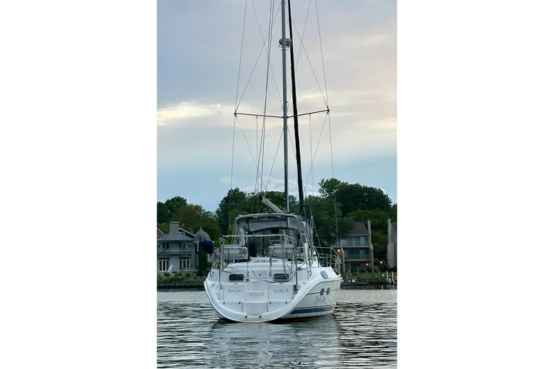 Slide: The Image of Sailboat Hunter Passage 420, 2002 model, docked on calm water at sunset. - 3