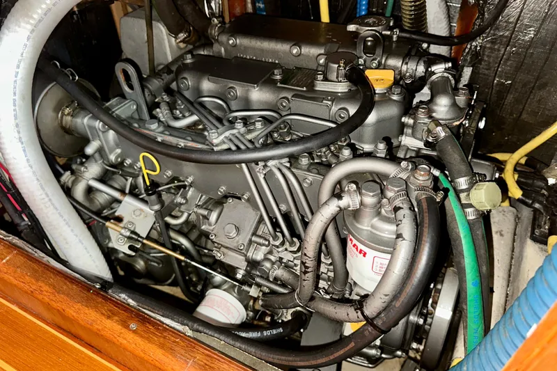 Slide: The Image of Engine of a 2002 Hunter Passage 420 sailboat, showcasing intricate mechanical components. - 31