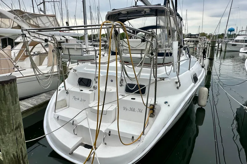 Slide: The Image of Hunter Passage 420 sailboat, 2002 model, docked in a marina with surrounding vessels. - 5
