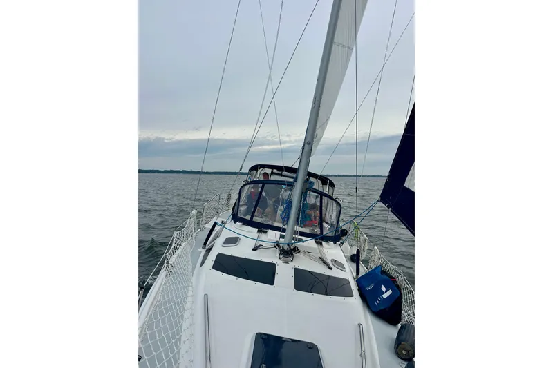 Slide: The Image of Sailing on a 2002 Hunter Passage 420 yacht, open waters, overcast sky. - 6