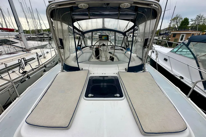 Slide: The Image of 2002 Hunter Passage 420 sailboat cockpit view in marina setting. - 9