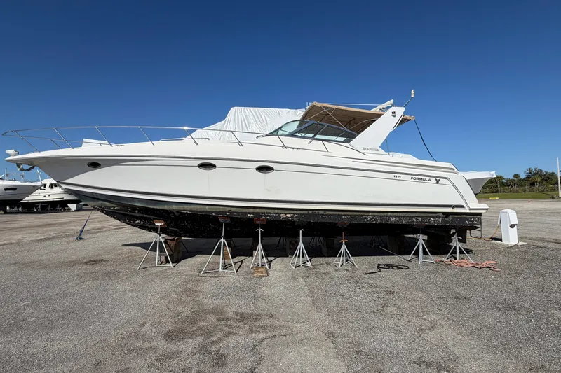 The Image of 2000 Formula 41 Performance Cruiser on stands, displayed outdoors under clear blue sky. - 0