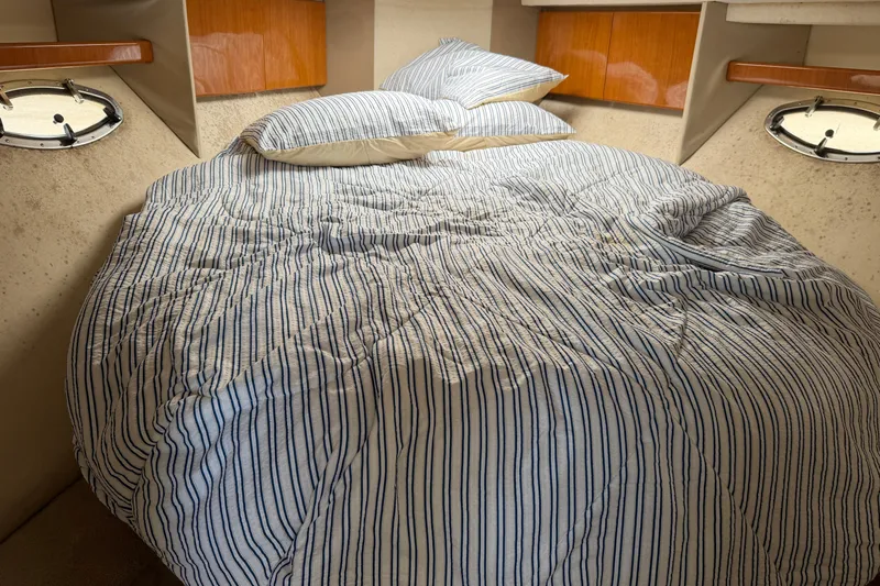 Slide: The Image of Cozy cabin interior of 2000 Formula 41 Performance Cruiser with striped bedding. - 10