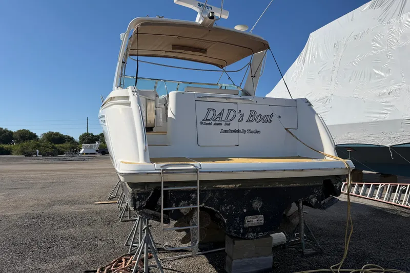 Slide: The Image of 2000 Formula 41 Performance Cruiser named "DAD's Boat" on dry dock under clear sky. - 3