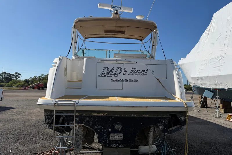 Slide: The Image of Rear view of a 2000 Formula 41 Performance Cruiser named "DAD's Boat" on land. - 4