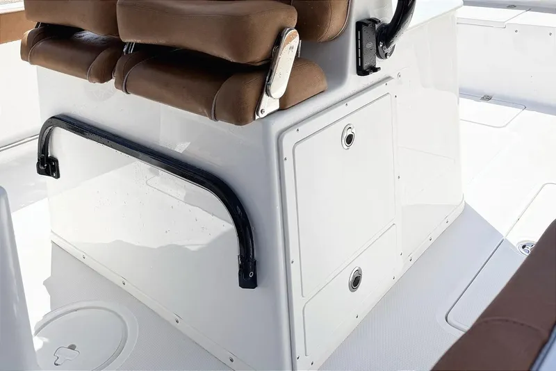 Slide: The Image of 2026 Seahunt Ultra 305 CB boat interior with brown seating and storage compartments. - 10