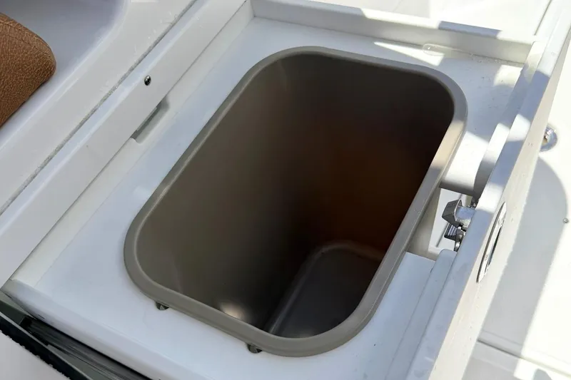 Slide: The Image of Sea Hunt Ultra 305 Coffin Box 2026 with open storage compartment. - 12