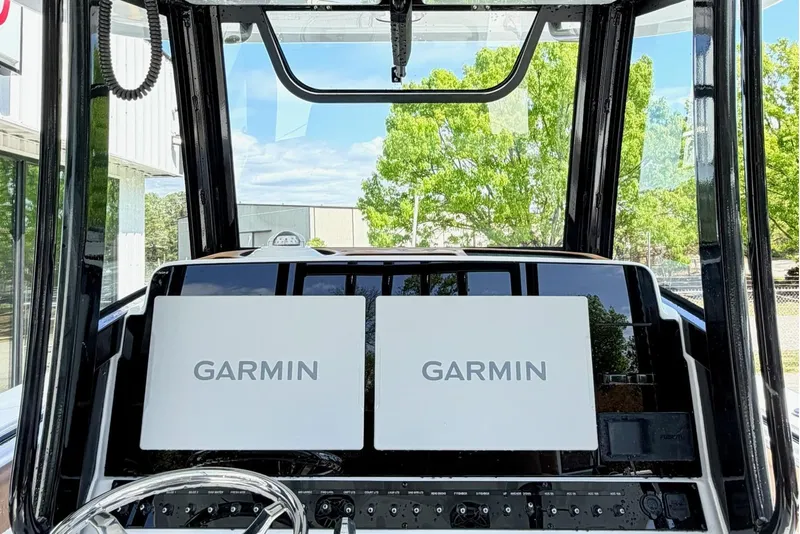 Slide: The Image of 2026 Seahunt Ultra 305 CB cockpit with dual Garmin displays and steering wheel. - 16