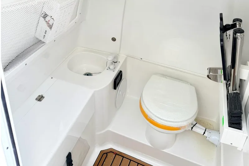 Slide: The Image of Interior of Sea Hunt Ultra 305 Coffin Box 2026 with toilet and sink. - 19