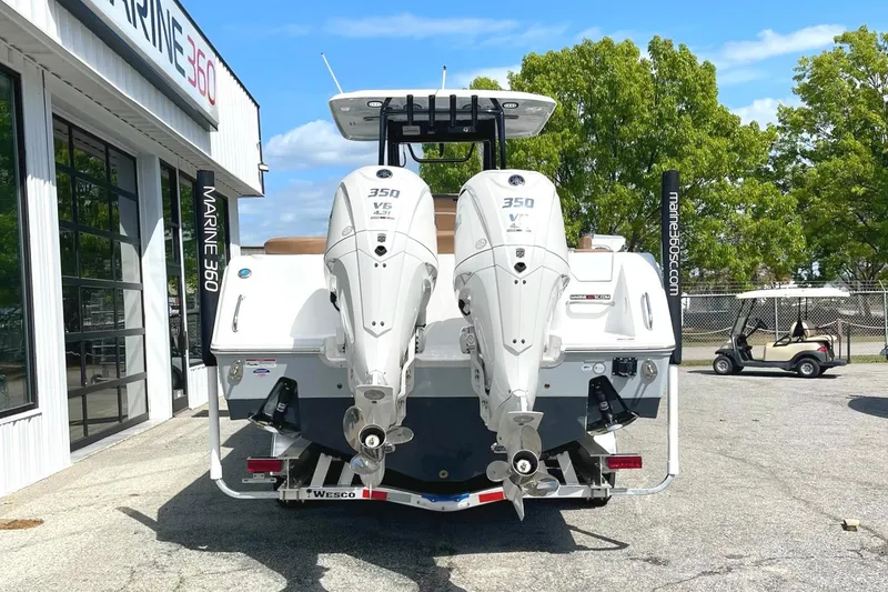 Slide: The Image of 2026 Seahunt Ultra 305 CB boat with twin 350 V6 engines at Marine 360 dealership. - 2