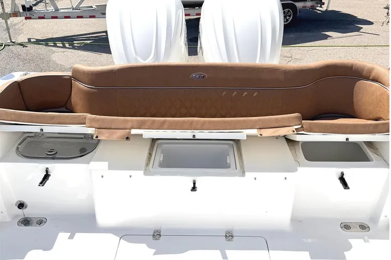Slide: The Image of 2026 Seahunt Ultra 305 CB boat interior with brown seating and storage compartments. - 5