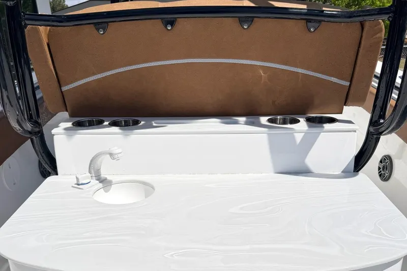 Slide: The Image of 2026 Seahunt Ultra 305 CB boat interior with sink and cup holders. - 7