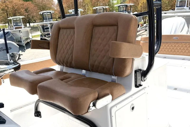 Slide: The Image of 2026 Seahunt Ultra 305 CB boat with luxurious brown seating and armrests. - 9