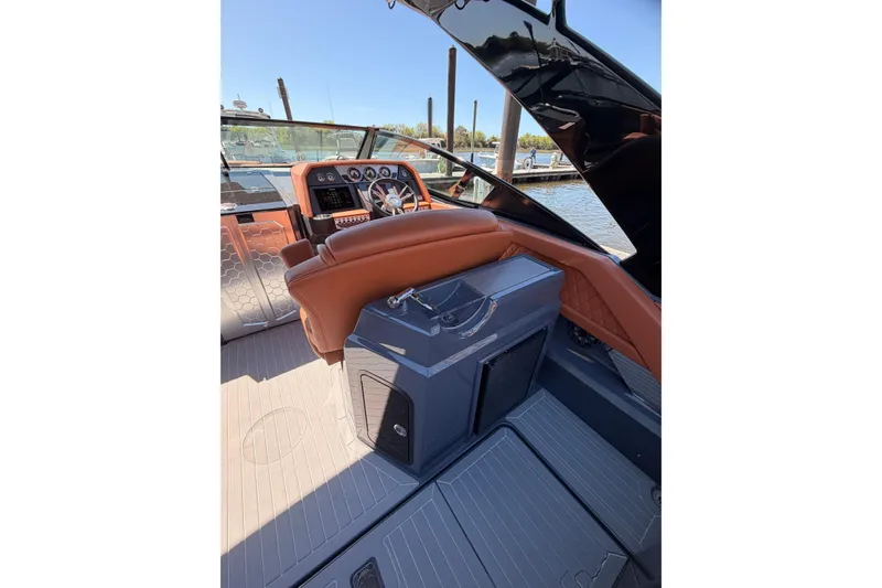 Slide: The Image of 2021 Cruisers Yachts 338 Bow Rider helm with luxurious seating and modern dashboard. - 15