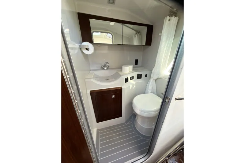 Slide: The Image of 2021 Cruisers Yachts 338 Bow Rider bathroom with sink, toilet, and mirror. - 16