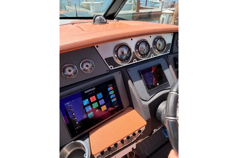 Slide: The Image of 2021 Cruisers Yachts 338 Bow Rider dashboard with Simrad display and gauges. - 20
