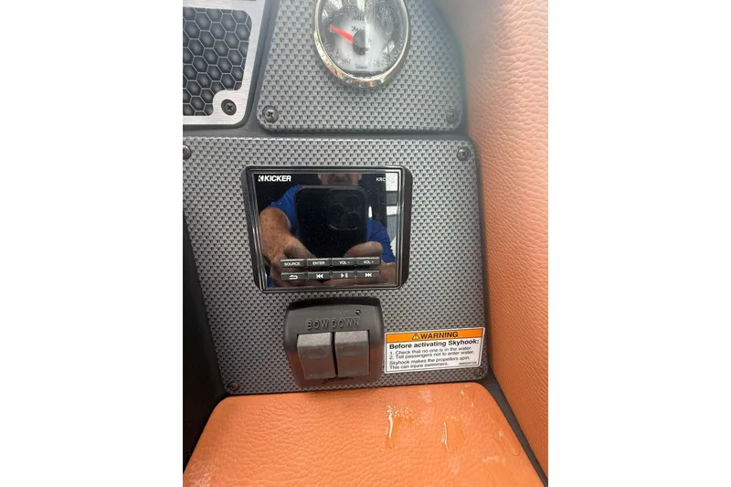 Slide: The Image of 2021 Cruisers Yachts 338 Bow Rider dashboard with Kicker audio system and controls. - 25