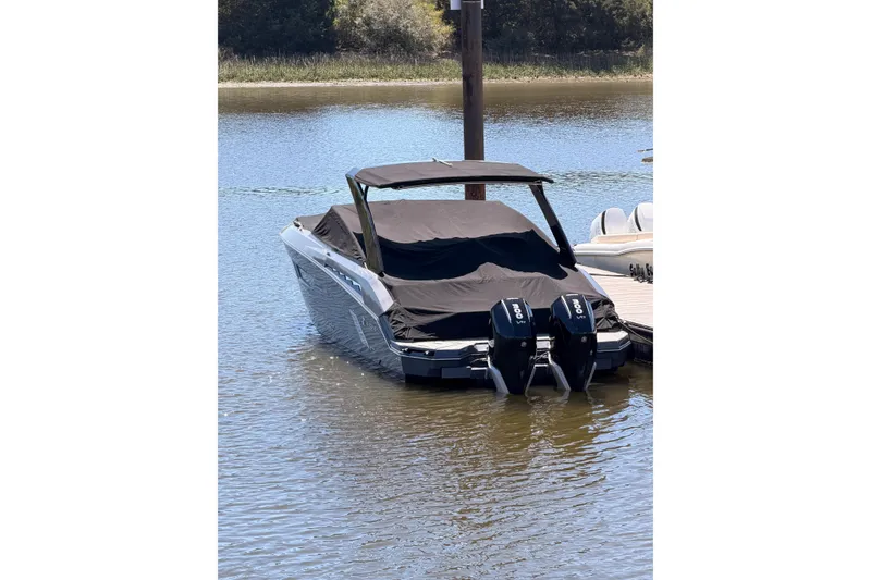 Slide: The Image of 2021 Cruisers Yachts 338 Bow Rider with dual engines, docked and covered. - 27